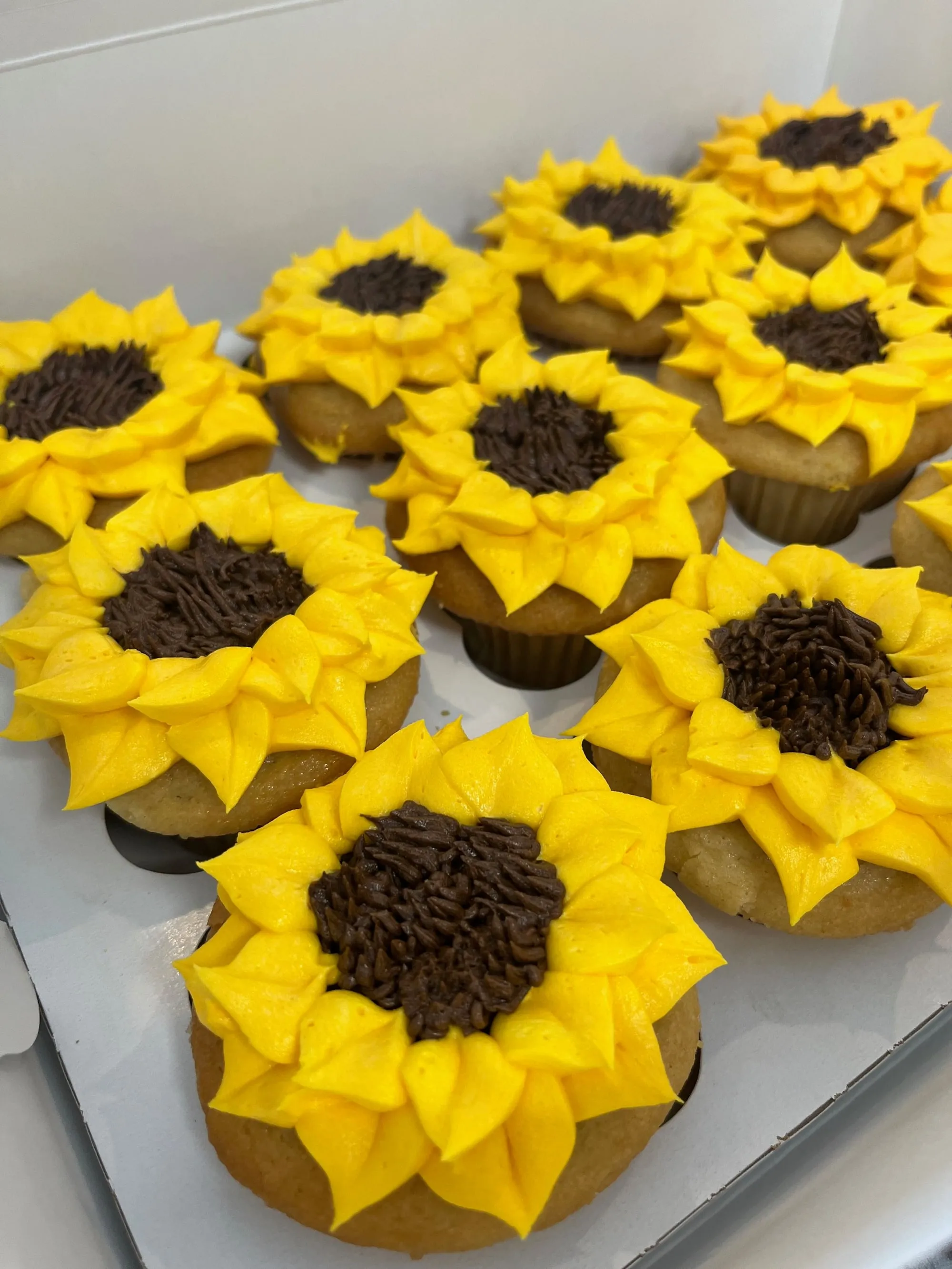 Sunflower cupcakes piped in yellow buttercream at BAM Desserts