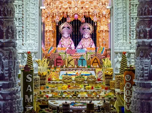 Tiers of vegetarian dishes and sweets offered before the shrine for the Annakut at BAPS Parsippany