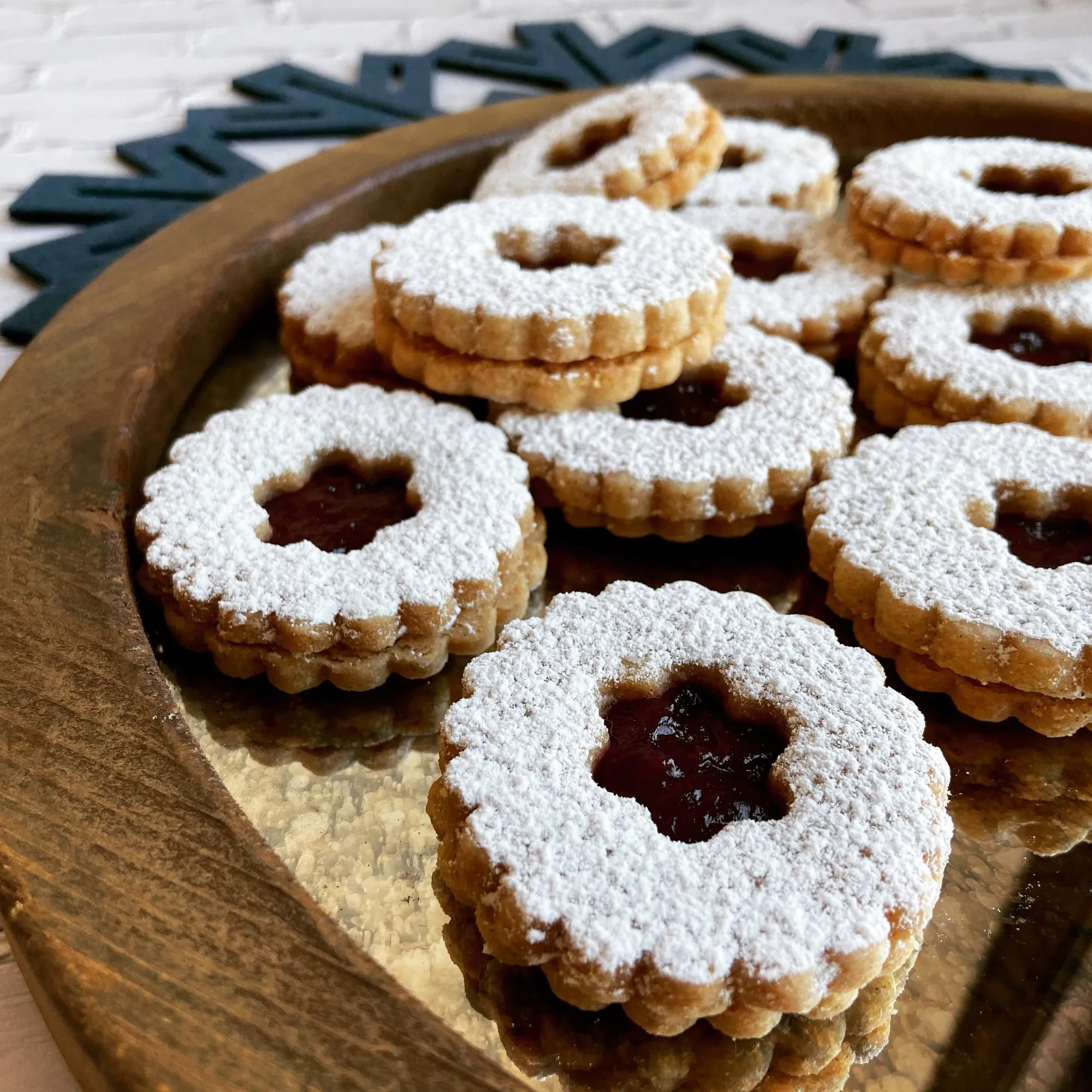 Raspberry linzer cookies dusted with powdered sugar at Cookie Maven