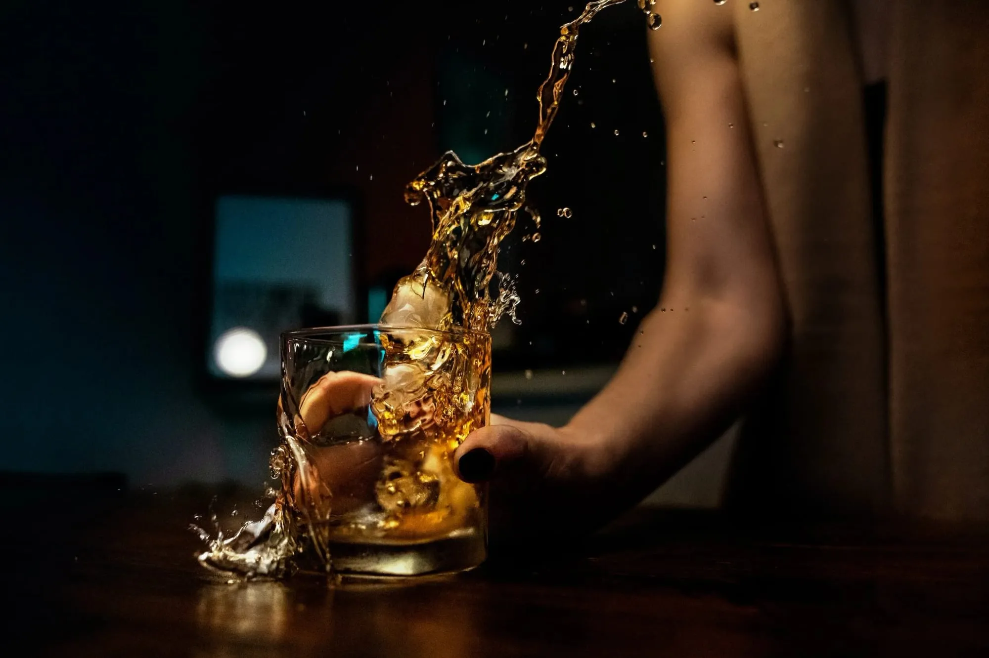 A pour splashing into a glass at Dismal Harmony Distilling