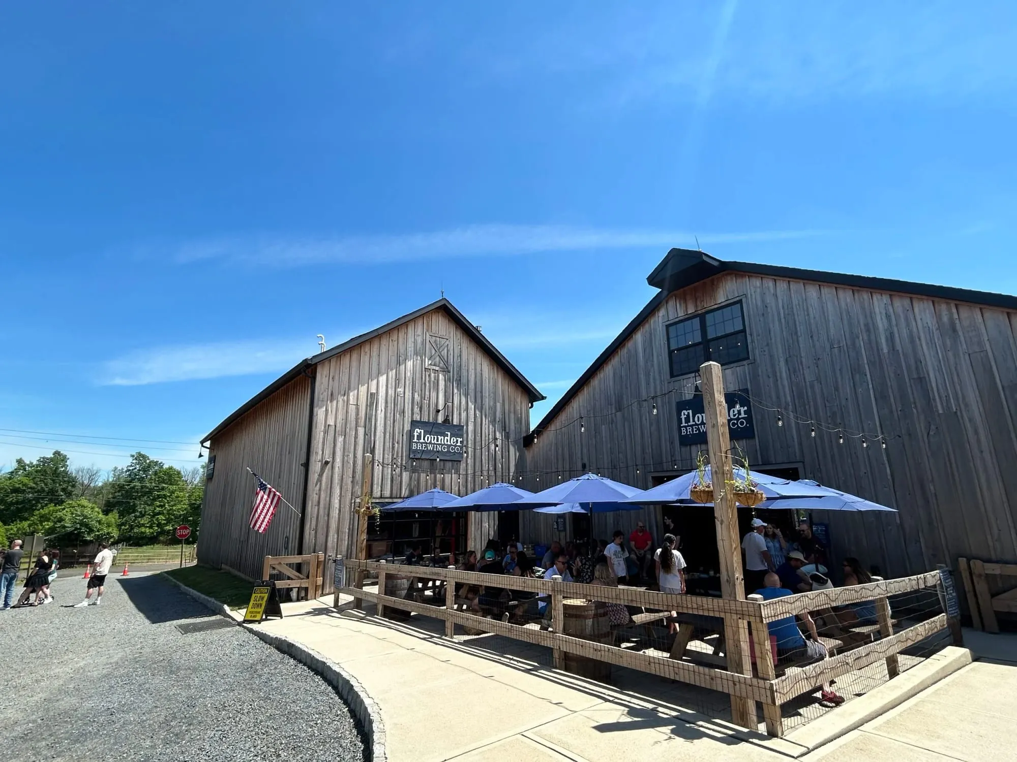 Flounder Brewing’s restored barn and patio on Carriage Farm