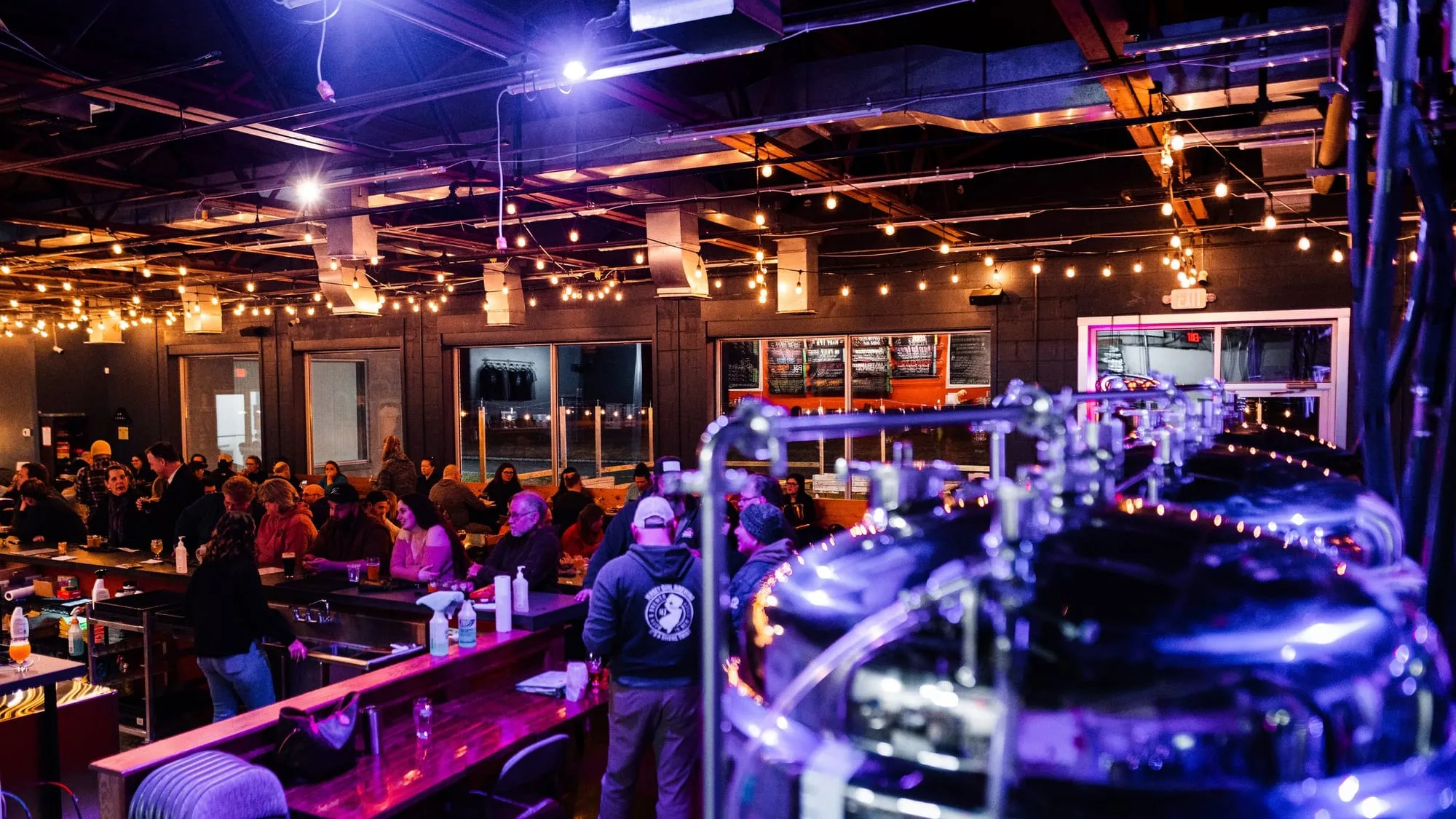 The Fort Nonsense Brewing taproom lit up on a busy night