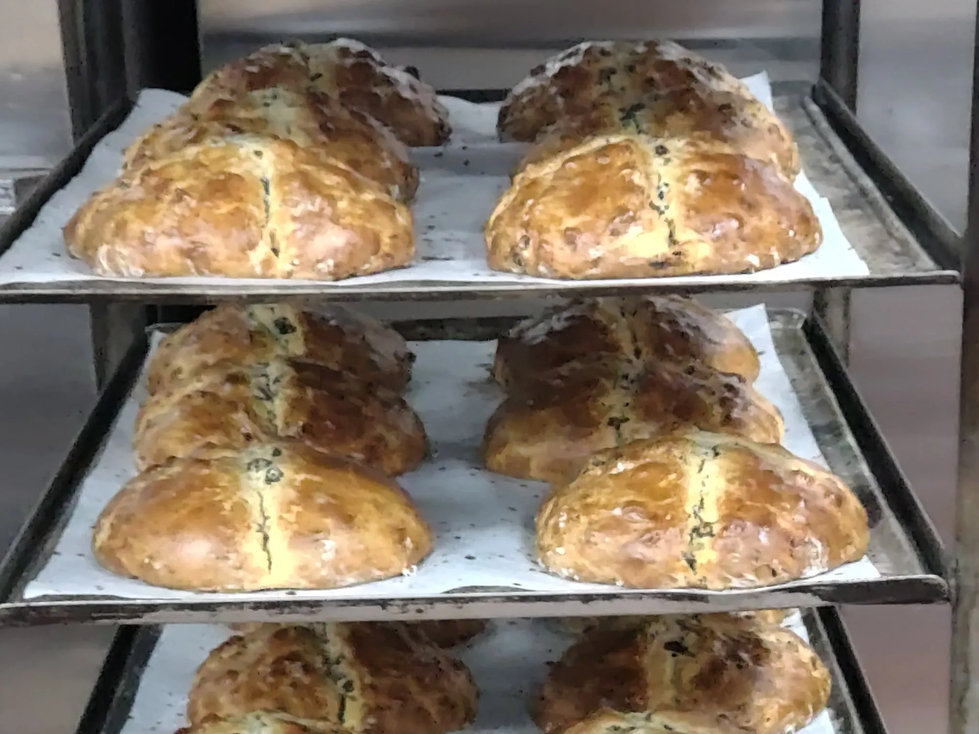Loaves of Irish soda bread cooling on a rack at Harper’s Bakery