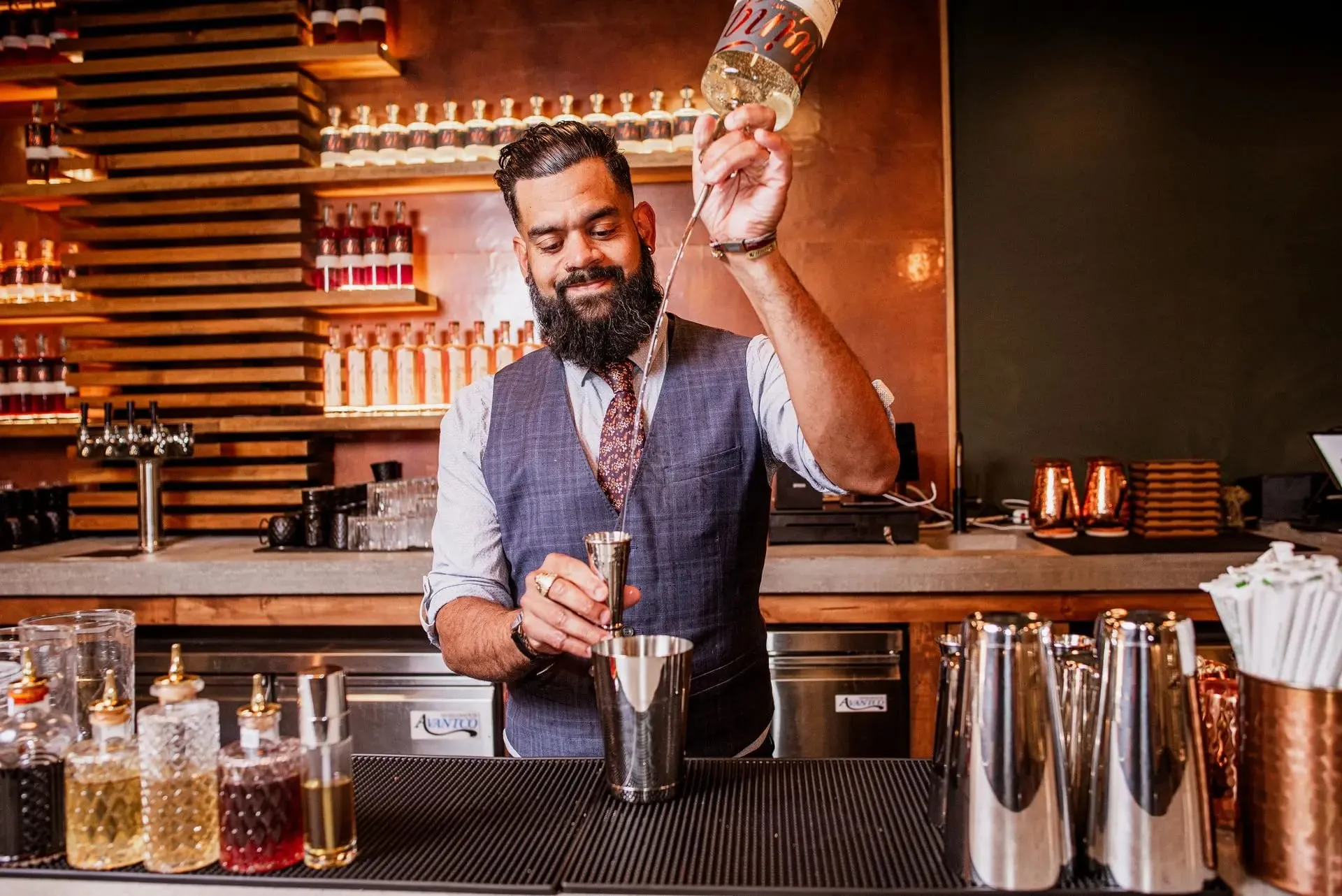 A bartender mixing a cocktail at Living Spirits Craft Distillery