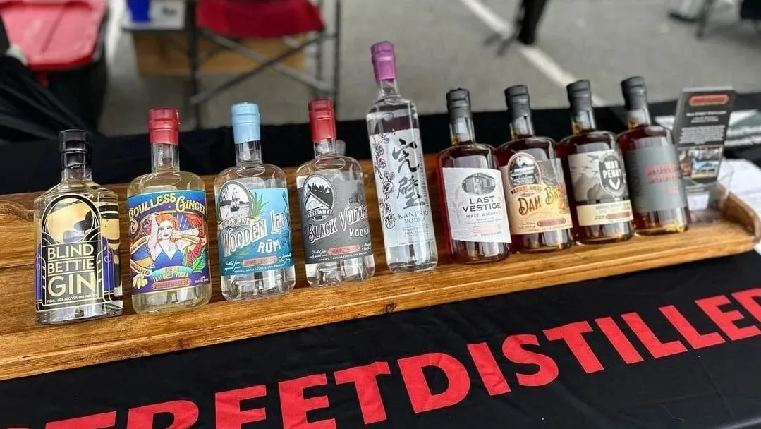 A row of Milk Street Distillery bottles on the bar