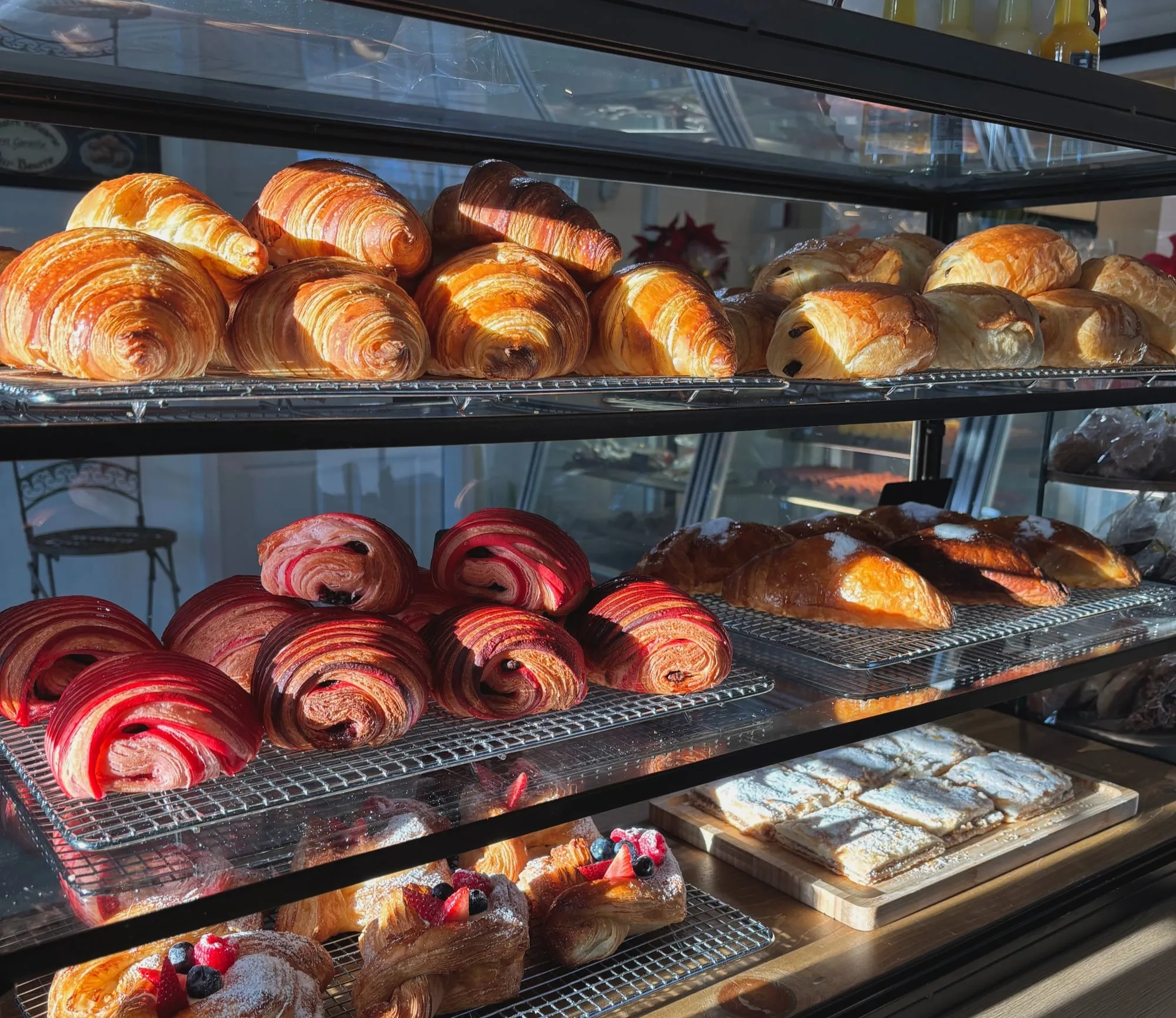A case of fresh croissants and pastries at NinaLou Patisserie