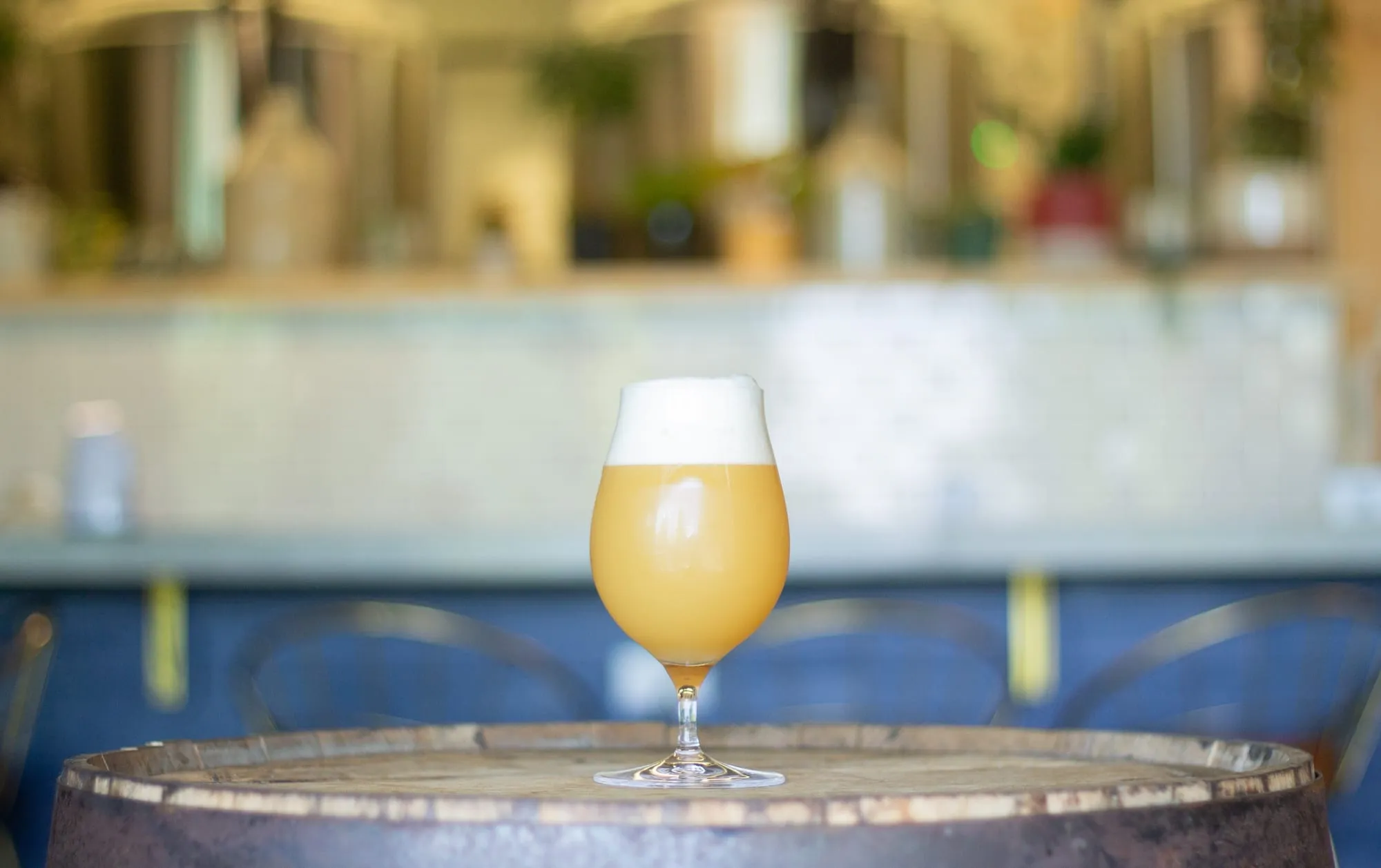 A glass of hazy beer on a barrel at Oakflower Brewing