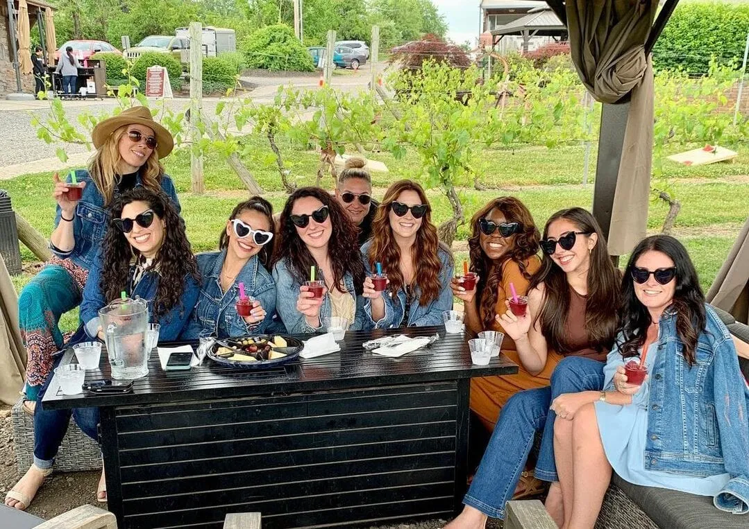 Friends sharing wine on the terrace at Old York Cellars
