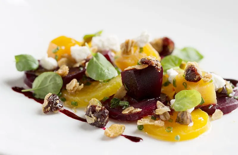 Roasted red and golden beets with goat cheese, granola, dried fruit and watercress